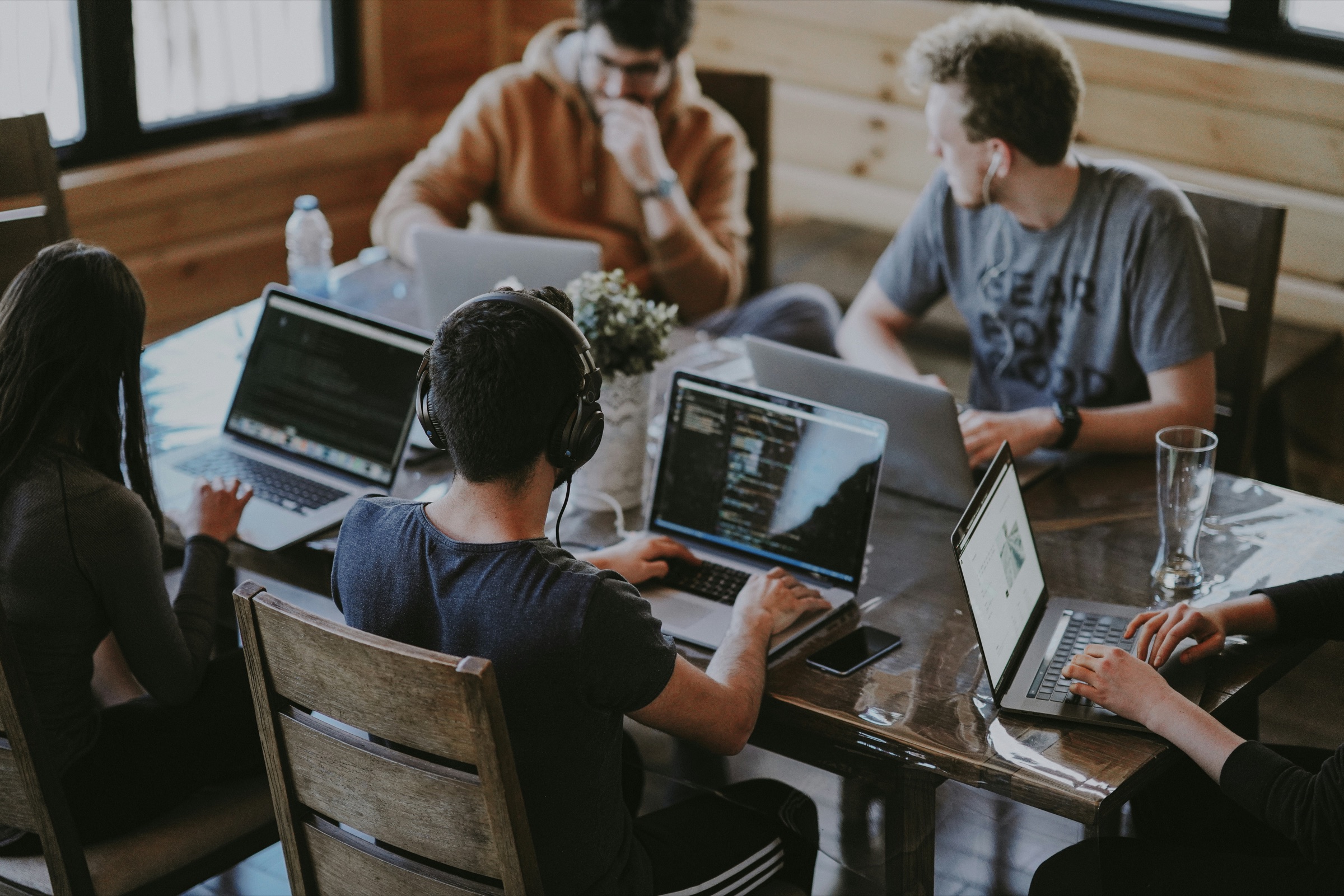 Game developers working together around laptops